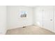 Bedroom featuring neutral carpet, a window, and a door at 1246 Nc-27, Benson, NC 27504