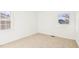 Bright bedroom featuring neutral carpet and two windows at 1246 Nc-27, Benson, NC 27504