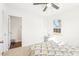 Bright bedroom featuring carpet, a ceiling fan, and a geometric patterned bed cover at 1246 Nc-27, Benson, NC 27504
