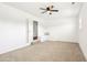 Bright bedroom with neutral carpet, ceiling fan, and built-in seat with decorative pillows at 1246 Nc-27, Benson, NC 27504
