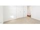 Bedroom featuring neutral carpet, two doors, and access to another room at 1246 Nc-27, Benson, NC 27504