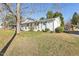 White brick one-story home with green lawn, gray shutters and front wooden porch columns at 1246 Nc-27, Benson, NC 27504