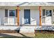 Painted blue front door with sturdy wooden columns, painted steps and walkway to the lawn of this one-story home at 1246 Nc-27, Benson, NC 27504