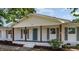 A charming front porch with sturdy wooden columns and a painted blue front door of this one-story home at 1246 Nc-27, Benson, NC 27504