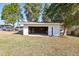 Exterior view of detached garage; ample parking space, mature trees, and sunny skies at 1246 Nc-27, Benson, NC 27504
