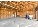 Interior view of detached garage featuring exposed rafters and storage along the walls at 1246 Nc-27, Benson, NC 27504