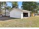 Exterior view of detached garage; ample parking space, mature trees, and sunny skies at 1246 Nc-27, Benson, NC 27504