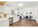 Well-lit kitchen featuring white cabinets, stainless appliances, and an adjacent dining area at 1246 Nc-27, Benson, NC 27504