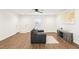 Bright living room with hardwood floors, white walls, and furniture, including a leather sofa and wood entertainment center at 1246 Nc-27, Benson, NC 27504