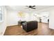 Inviting living room featuring wood flooring, leather sofa, and seamless connection to the modern kitchen at 1246 Nc-27, Benson, NC 27504