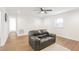 Bright and open living room featuring a leather sofa, modern lighting, and wood flooring at 1246 Nc-27, Benson, NC 27504