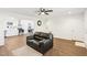 Open-concept living room featuring a leather sofa, wood flooring, and a view into the kitchen and dining area at 1246 Nc-27, Benson, NC 27504