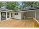 Large wooden deck with a white painted exterior and private backyard at 132 Edgewood Dr, Louisburg, NC 27549