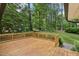 Wooden deck surrounded by mature trees, providing a private outdoor space at 132 Edgewood Dr, Louisburg, NC 27549