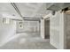 Large unfinished basement ready for customization, with exposed ductwork, a window and an adjacent room at 132 Edgewood Dr, Louisburg, NC 27549