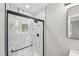 Marble tiled walk-in shower with black hardware and glass door at 132 Edgewood Dr, Louisburg, NC 27549