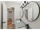 Modern bathroom featuring double sinks with granite countertops and black hardware, plus stylish lighting and round mirrors at 132 Edgewood Dr, Louisburg, NC 27549
