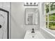 Bathroom with black and white sink and view of shower at 132 Edgewood Dr, Louisburg, NC 27549