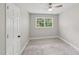 Neutral bedroom featuring carpet, a ceiling fan, and large window at 132 Edgewood Dr, Louisburg, NC 27549