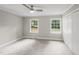 Neutral bedroom with two windows, carpet, and a closet at 132 Edgewood Dr, Louisburg, NC 27549