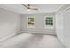 Neutral bedroom featuring carpet, two windows, and a closet at 132 Edgewood Dr, Louisburg, NC 27549