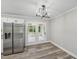 Dining area with stainless refrigerator and double doors leading to a sunroom at 132 Edgewood Dr, Louisburg, NC 27549