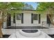 Close up of the home's front featuring white brick, black accents, and well-maintained landscaping at 132 Edgewood Dr, Louisburg, NC 27549