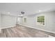 Bright, open-concept living room with grey walls, modern flooring, and natural light at 132 Edgewood Dr, Louisburg, NC 27549