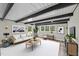 Bright living room with dark wood ceiling beams, hardwood floors and many windows with natural light at 132 Edgewood Dr, Louisburg, NC 27549