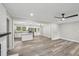 Open-concept space connecting living area and kitchen, creating a spacious feel with a ceiling fan at 132 Edgewood Dr, Louisburg, NC 27549