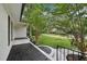 Inviting front porch with black textured flooring and black railings, offering a serene outdoor space at 132 Edgewood Dr, Louisburg, NC 27549