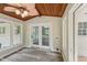 Sunroom with wood ceiling and fan that offers lots of natural light and view to backyard at 132 Edgewood Dr, Louisburg, NC 27549