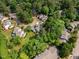 A picturesque aerial view displays homes with lush trees in a neighborhood setting at 1600 Budwood Dr, Raleigh, NC 27609