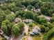 Aerial view of homes nestled among dense trees in a well-established neighborhood at 1600 Budwood Dr, Raleigh, NC 27609