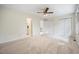Bright bedroom with neutral carpet, ceiling fan, and attached bath and closets at 1600 Budwood Dr, Raleigh, NC 27609