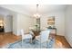 Inviting dining area featuring a glass table, stylish chairs, and a decorative area rug at 1600 Budwood Dr, Raleigh, NC 27609