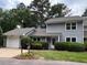 Charming gray home features a well-manicured lawn, inviting entrance, and attached one car garage at 1600 Budwood Dr, Raleigh, NC 27609