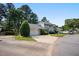Well-maintained townhome featuring an attached garage and landscaped front yard in a serene, tree-lined neighborhood at 1600 Budwood Dr, Raleigh, NC 27609