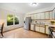 Well-lit kitchen with stainless steel appliances and a view of the green outdoors from the adjacent window at 1600 Budwood Dr, Raleigh, NC 27609