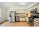 Efficient kitchen boasts stainless steel appliances and ample cabinet space; perfect for cooking and storage at 1600 Budwood Dr, Raleigh, NC 27609