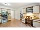 Functional kitchen space with a built-in desk area and staircase access, maximizing utility at 1600 Budwood Dr, Raleigh, NC 27609