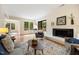 Bright living room featuring a fireplace, natural light, and an open floor plan flowing into the dining area at 1600 Budwood Dr, Raleigh, NC 27609