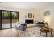 Inviting living room with a cozy fireplace, comfortable seating, and access to the outdoor deck at 1600 Budwood Dr, Raleigh, NC 27609