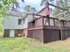 Exterior view of a house featuring a wooden deck with a pergola and latticework at 1609 Cypress Dr, Henderson, NC 27536