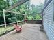 Relaxing back deck with wooden seating, a pergola, and a lush green yard at 1609 Cypress Dr, Henderson, NC 27536