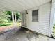 Covered back porch featuring white siding, window and door at 1609 Cypress Dr, Henderson, NC 27536