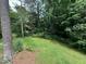 Secluded backyard with trees, offering a private outdoor space at 1609 Cypress Dr, Henderson, NC 27536