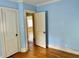 Bedroom featuring light blue walls and hardwood flooring at 1609 Cypress Dr, Henderson, NC 27536