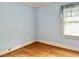 Bedroom featuring light blue walls, hardwood flooring, and natural light at 1609 Cypress Dr, Henderson, NC 27536