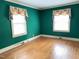 Bedroom featuring natural light from two windows with floral valances at 1609 Cypress Dr, Henderson, NC 27536